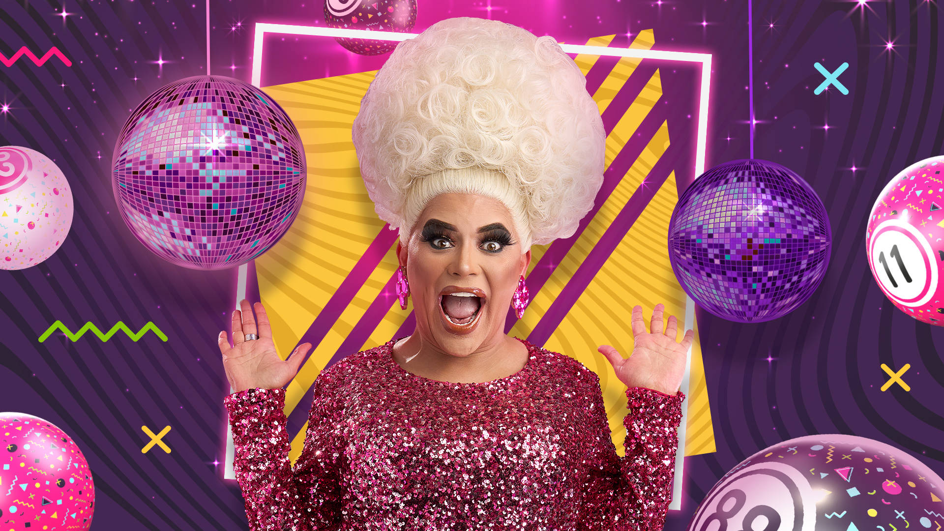 Drag Queen Baga Chipz surrounded by disco and bingo balls