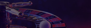 Close-up of a roulette wheel with a ball, suggesting casino gaming.
